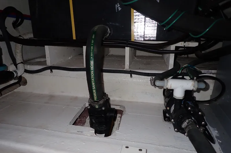 Slide: The Image of 2023 True North 34 Outboard Express boat plumbing system with sanitation hose and pump. - 112
