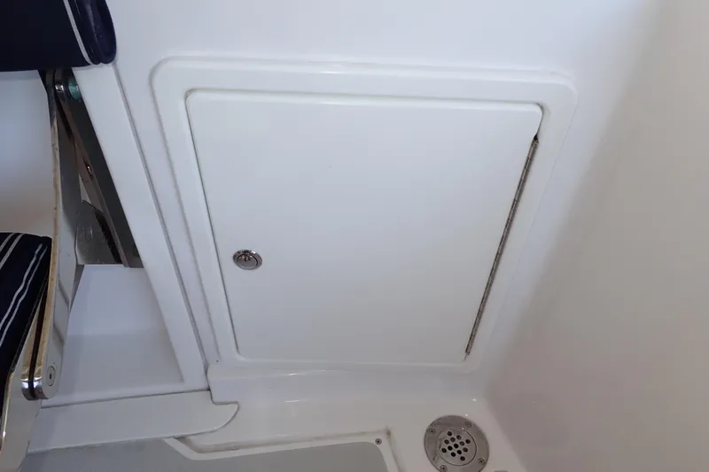 Slide: The Image of 2023 True North 34 Outboard Express interior compartment with drain and seating detail. - 115