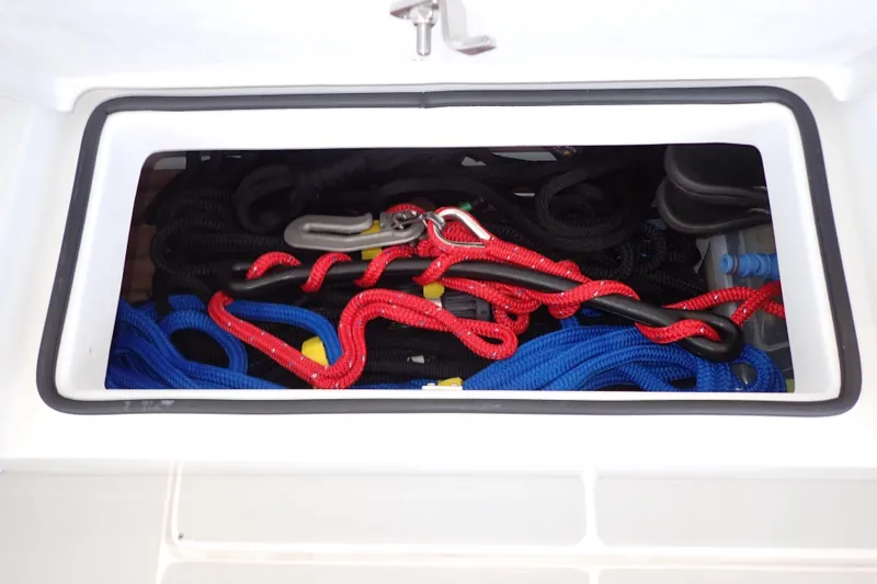 Slide: The Image of Storage compartment with colorful ropes on a 2023 True North 34 Outboard Express boat. - 119