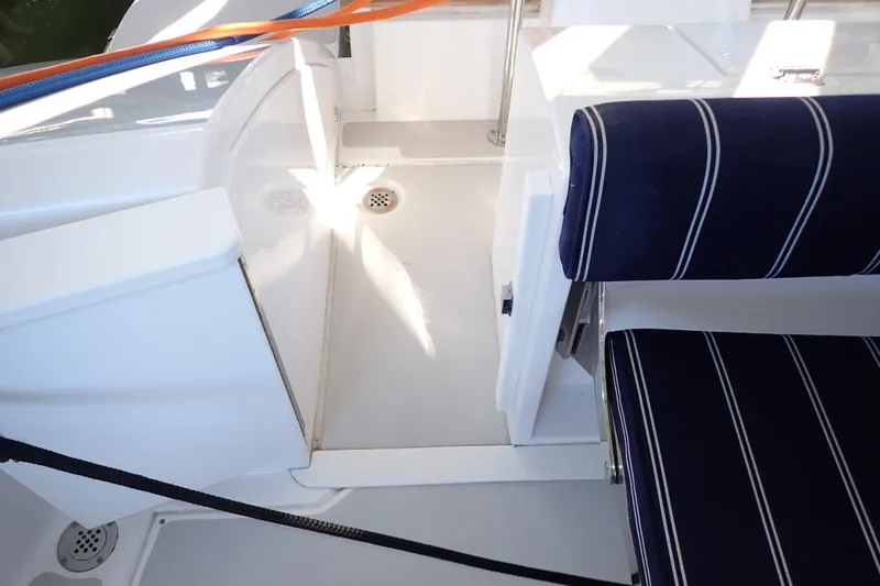Slide: The Image of Interior of 2023 True North 34 Outboard Express boat with striped seating. - 121