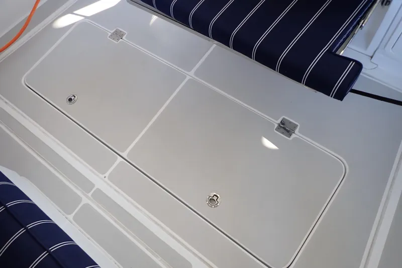 Slide: The Image of 2023 True North 34 Outboard Express deck with striped seating and storage hatch. - 128