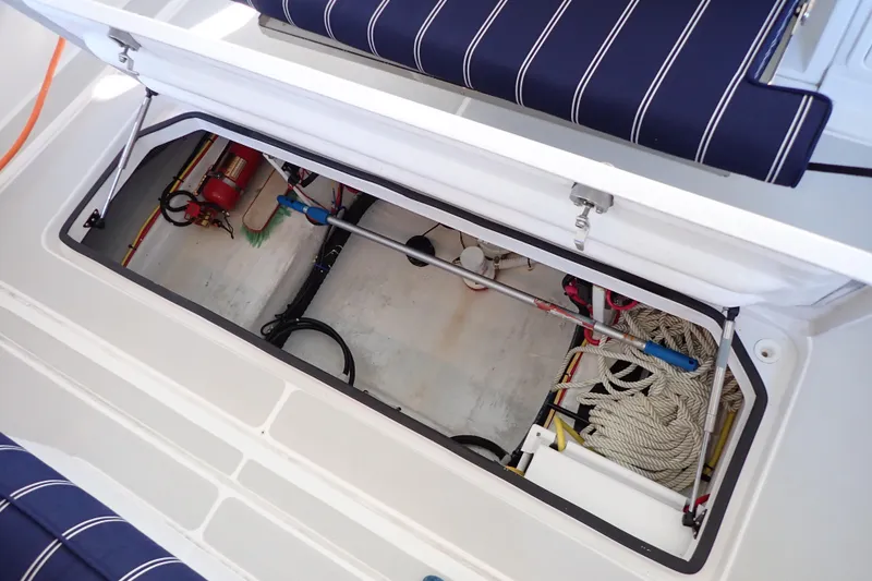 Slide: The Image of 2023 True North 34 Outboard Express boat storage compartment with ropes and equipment. - 129