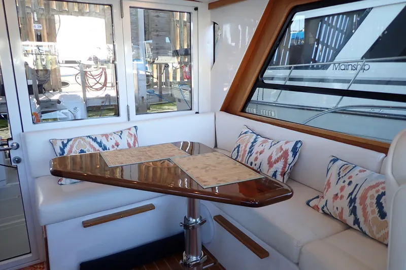 Slide: The Image of Interior of 2023 True North 34 Outboard Express with elegant seating and decorative pillows. - 13