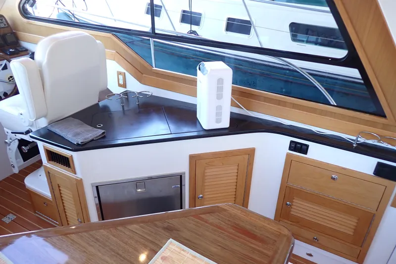 Slide: The Image of Interior of 2023 True North 34 Outboard Express yacht with modern amenities and wood finish. - 14
