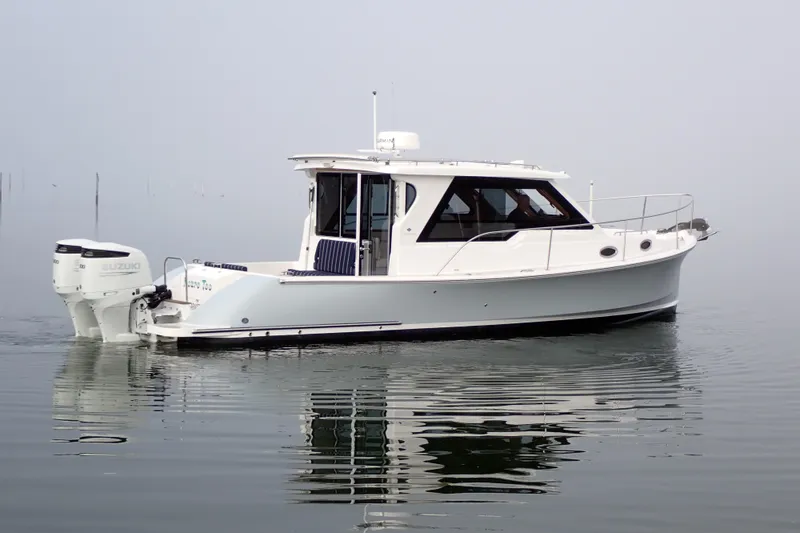 Slide: The Image of 2023 True North 34 Outboard Express boat on calm water, side view. - 151