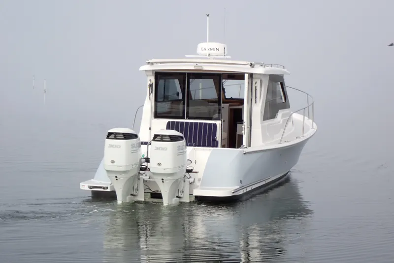 Slide: The Image of 2023 True North 34 Outboard Express boat on calm water, rear view. - 152