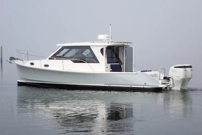 Slide: The Image of 2023 True North 34 Outboard Express boat on calm water. - 153