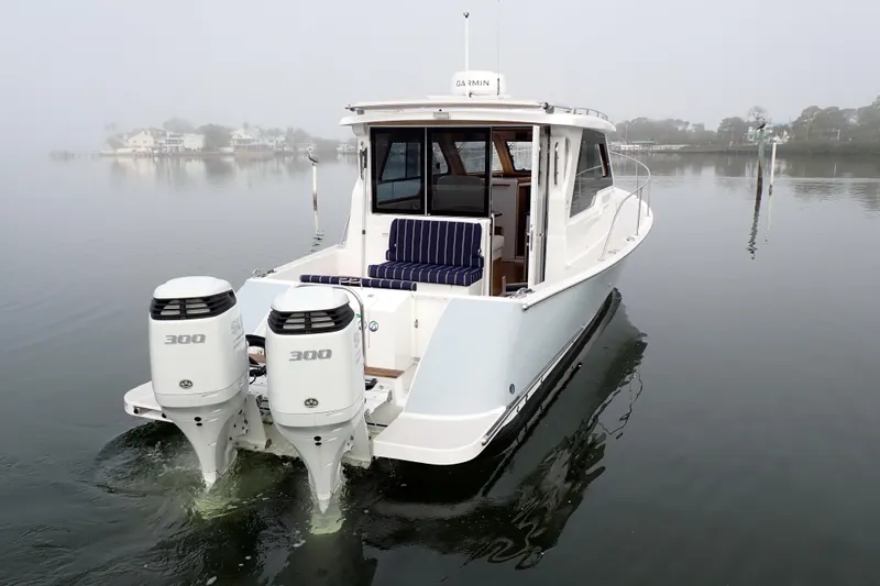 Slide: The Image of 2023 True North 34 Outboard Express boat with twin engines on calm water. - 154