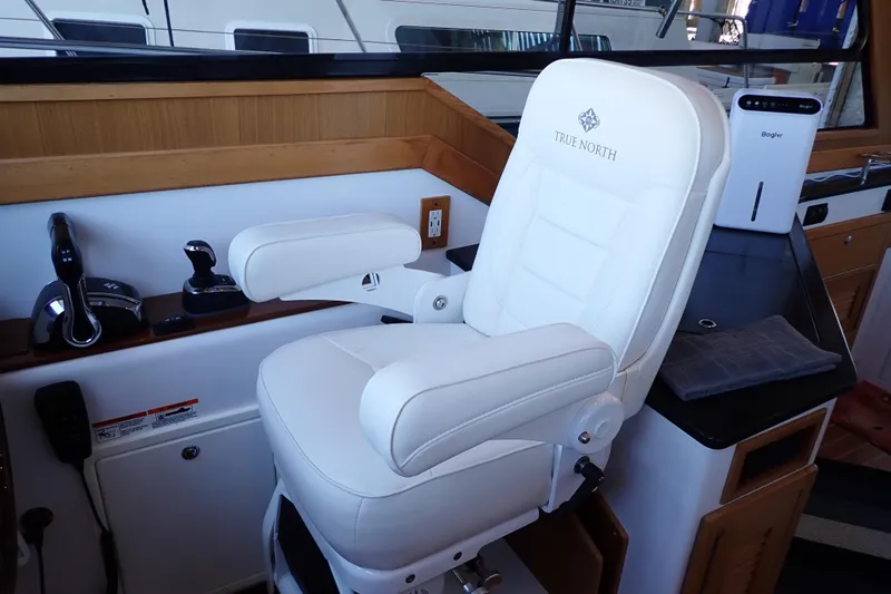 Slide: The Image of Captain's chair in 2023 True North 34 Outboard Express boat cockpit. - 18