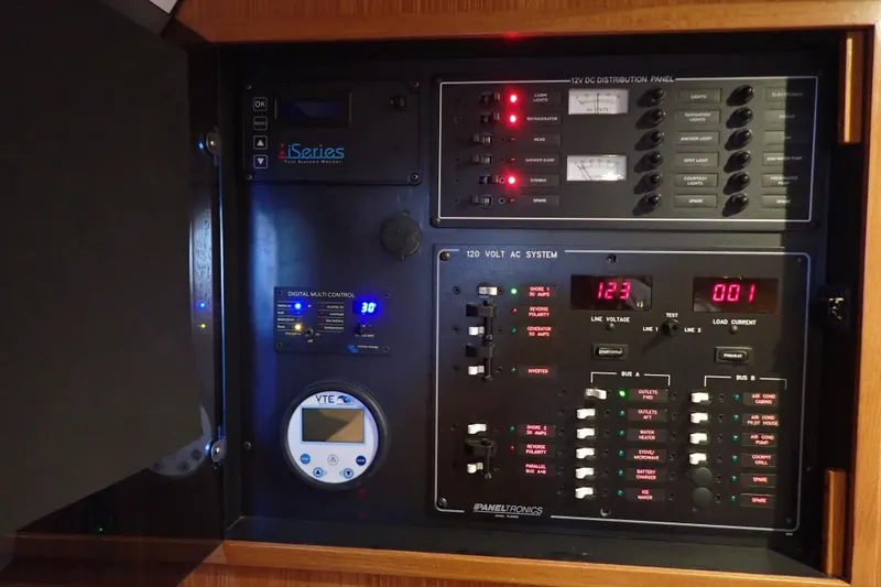 Slide: The Image of Electrical control panel on 2023 True North 34 Outboard Express boat, featuring various system displays. - 24