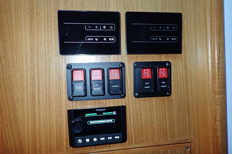 Slide: The Image of Control panel of 2023 True North 34 Outboard Express with switches and Bluetooth interface. - 25