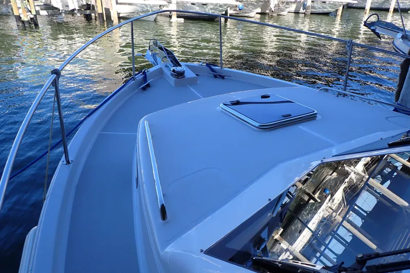 Slide: The Image of 2023 True North 34 Outboard Express boat deck, docked on calm water. - 27