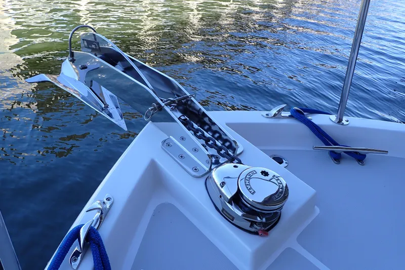 Slide: The Image of 2023 True North 34 Outboard Express anchor system on calm water. - 28
