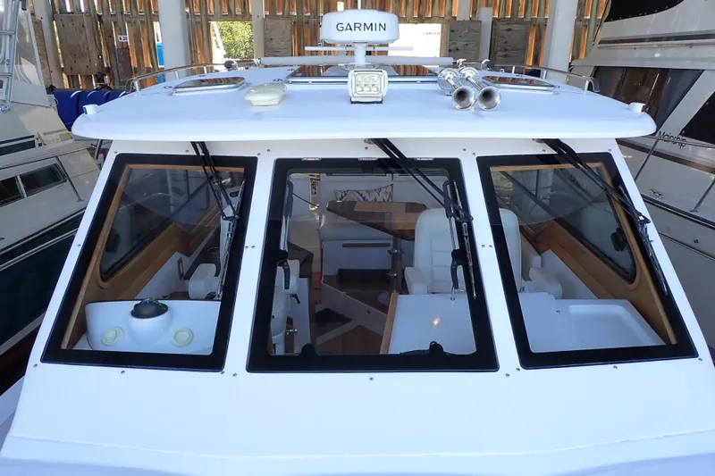 Slide: The Image of 2023 True North 34 Outboard Express boat with Garmin equipment, docked in a marina. - 29