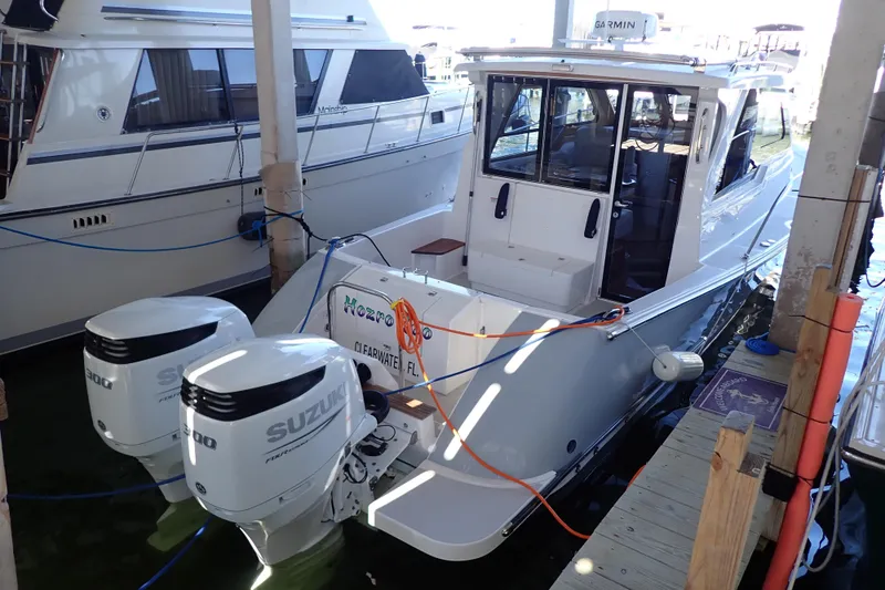 Slide: The Image of 2023 True North 34 Outboard Express docked with twin Suzuki engines. - 3