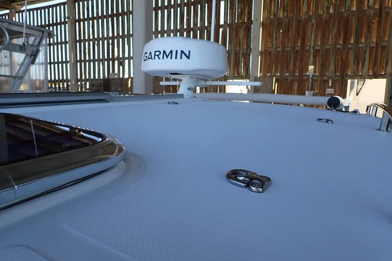 Slide: The Image of 2023 True North 34 Outboard Express boat deck with Garmin radar in a marina. - 31