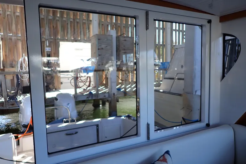 Slide: The Image of Interior view of 2023 True North 34 Outboard Express, showcasing dockside reflections. - 33