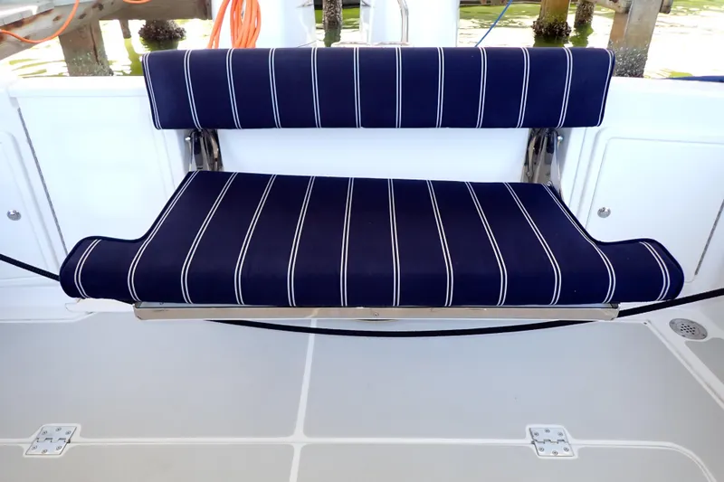 Slide: The Image of 2023 True North 34 Outboard Express boat seat with blue striped cushions. - 37