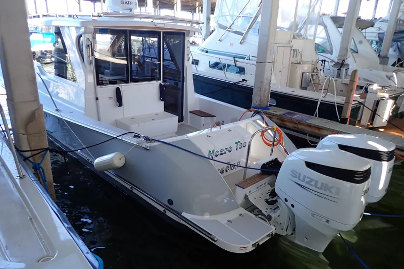 Slide: The Image of 2023 True North 34 Outboard Express boat docked with Suzuki engines. - 4