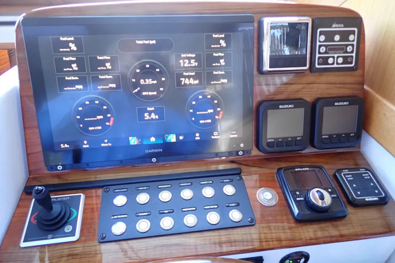 Slide: The Image of 2023 True North 34 Outboard Express dashboard with advanced navigation and control systems. - 48