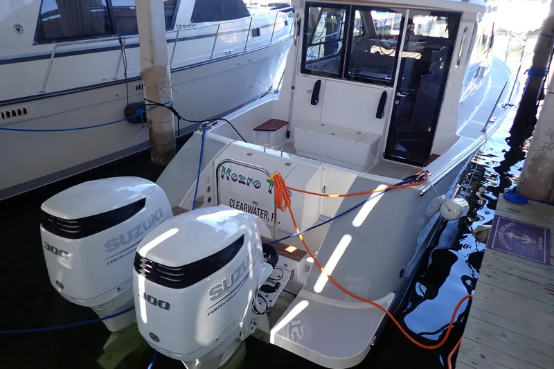 Slide: The Image of 2023 True North 34 Outboard Express boat docked with twin Suzuki engines. - 5
