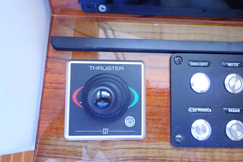 Slide: The Image of Control panel of 2023 True North 34 Outboard Express with thruster joystick and buttons. - 50