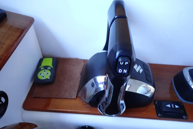 Slide: The Image of Control panel of 2023 True North 34 Outboard Express boat with throttle lever. - 55