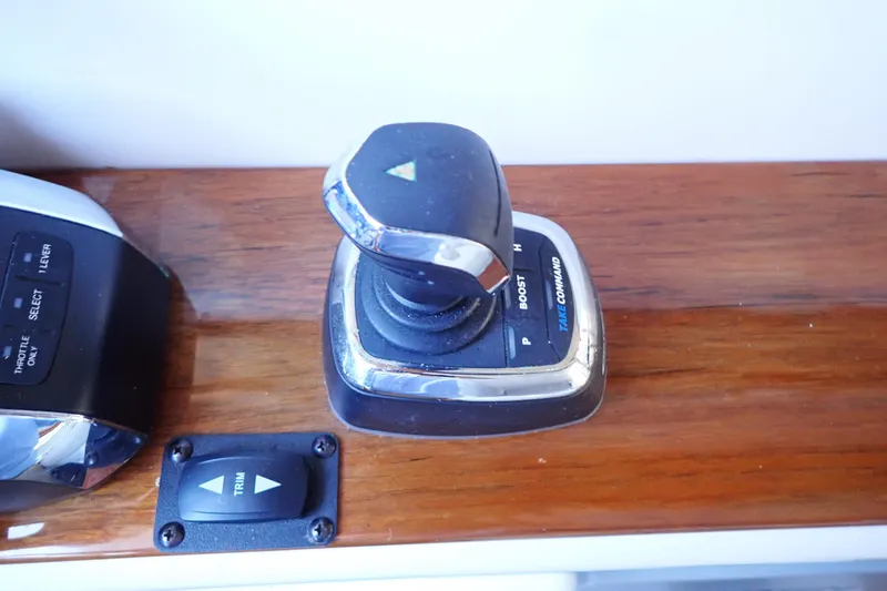 Slide: The Image of Control panel of 2023 True North 34 Outboard Express boat with joystick and trim buttons. - 56