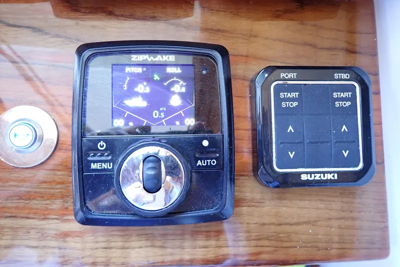 Slide: The Image of Control panel of 2023 True North 34 Outboard Express with Zipwake and Suzuki systems. - 57