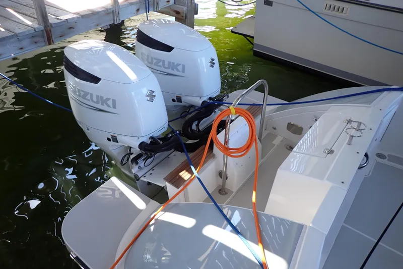 Slide: The Image of 2023 True North 34 Outboard Express with dual Suzuki engines docked. - 6