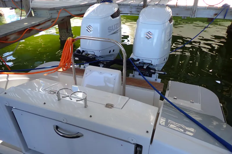 Slide: The Image of 2023 True North 34 Outboard Express with dual Suzuki engines docked. - 7