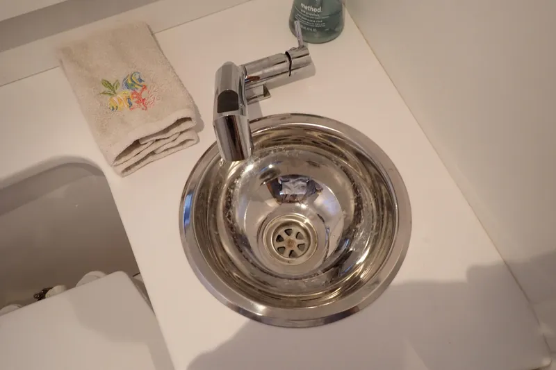 Slide: The Image of Stainless steel sink and faucet in 2023 True North 34 Outboard Express boat bathroom. - 75