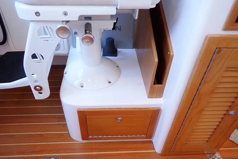 Slide: The Image of 2023 True North 34 Outboard Express interior with wooden cabinetry and seating. - 87