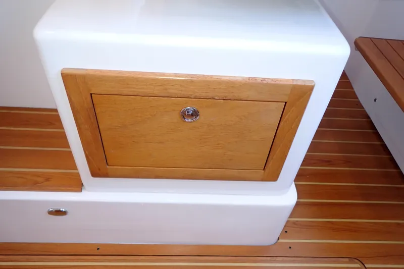 Slide: The Image of 2023 True North 34 Outboard Express, wooden storage compartment on teak deck. - 89