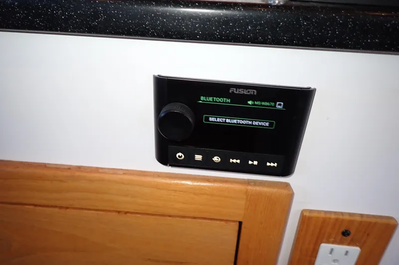 Slide: The Image of Control panel on 2023 True North 34 Outboard Express, featuring Bluetooth connectivity options. - 97