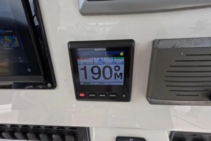 Slide: The Image of Control panel of a 2013 Boston Whaler 320 Outrage with radio and cup holders. - 16