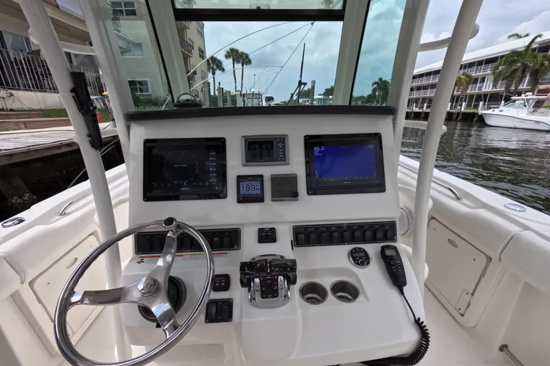 Slide: The Image of Interior of 2013 Boston Whaler 320 Outrage boat featuring a compact marine toilet. - 26