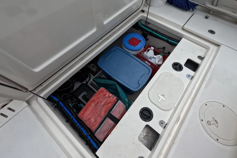 Slide: The Image of Interior of 2013 Boston Whaler 320 Outrage boat, featuring a compact marine toilet. - 27