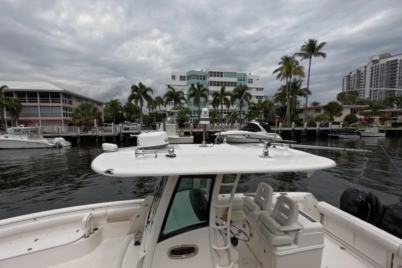 Slide: The Image of 2013 Boston Whaler 320 Outrage boat docked with dual outboard engines. - 33