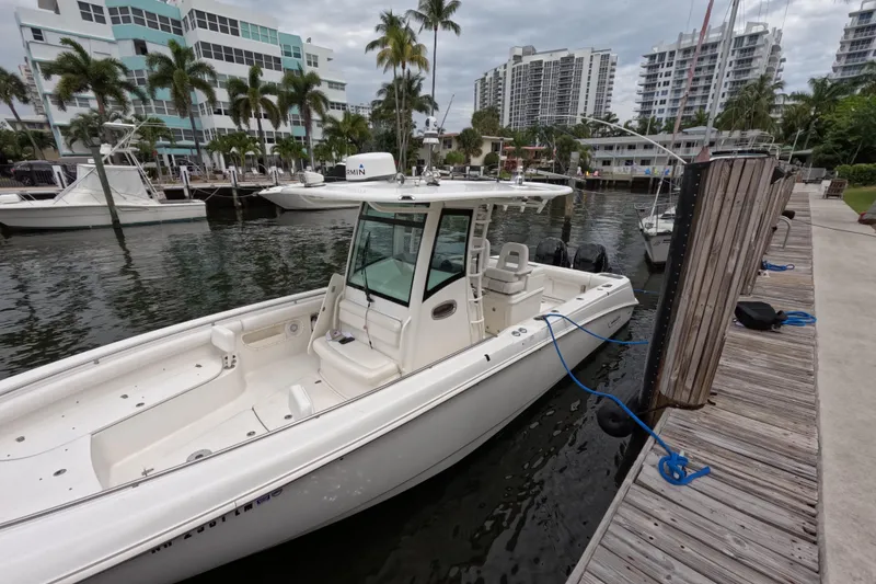 Slide: The Image of 2013 Boston Whaler 320 Outrage docked at marina, side view. - 34