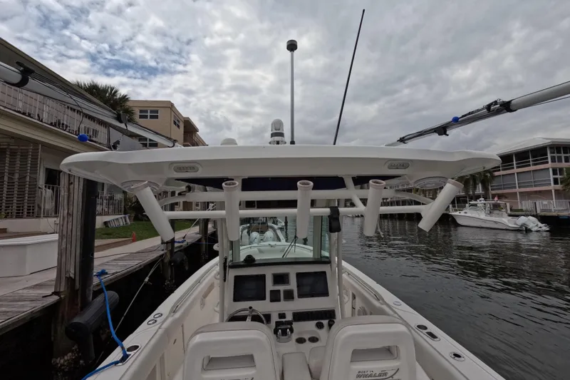 Slide: The Image of 2013 Boston Whaler 320 Outrage boat docked in marina, side view. - 37