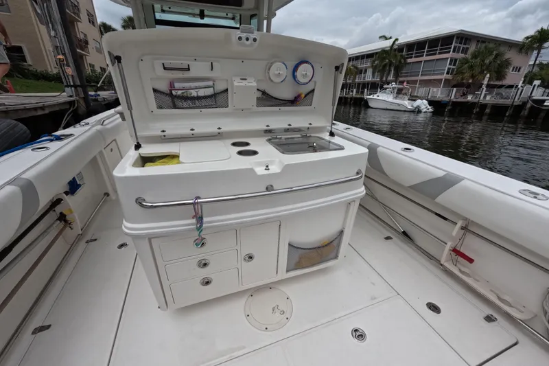 Slide: The Image of 2013 Boston Whaler 320 Outrage boat interior with helm, steering wheel, and seating. - 40