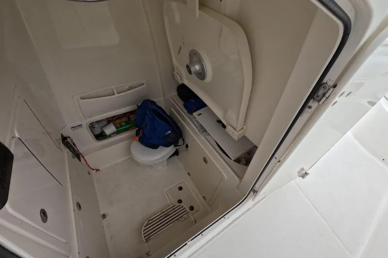 Slide: The Image of 2013 Boston Whaler 320 Outrage boat interior with storage compartments and sink. - 43