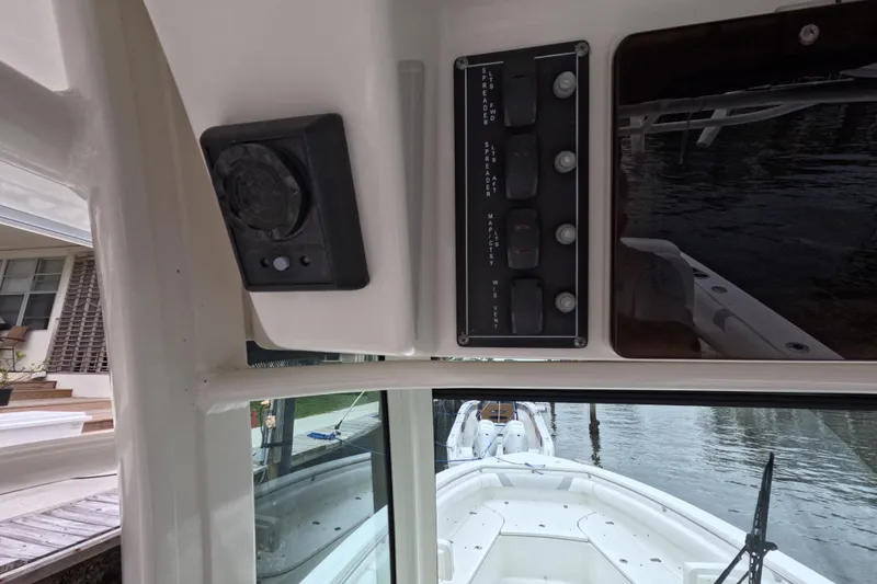 Slide: The Image of 2013 Boston Whaler 320 Outrage with twin Mercury outboard engines docked by the water. - 44
