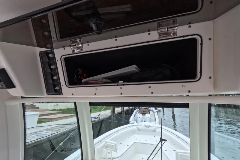 Slide: The Image of 2013 Boston Whaler 320 Outrage control panel and speaker, docked by the water. - 45