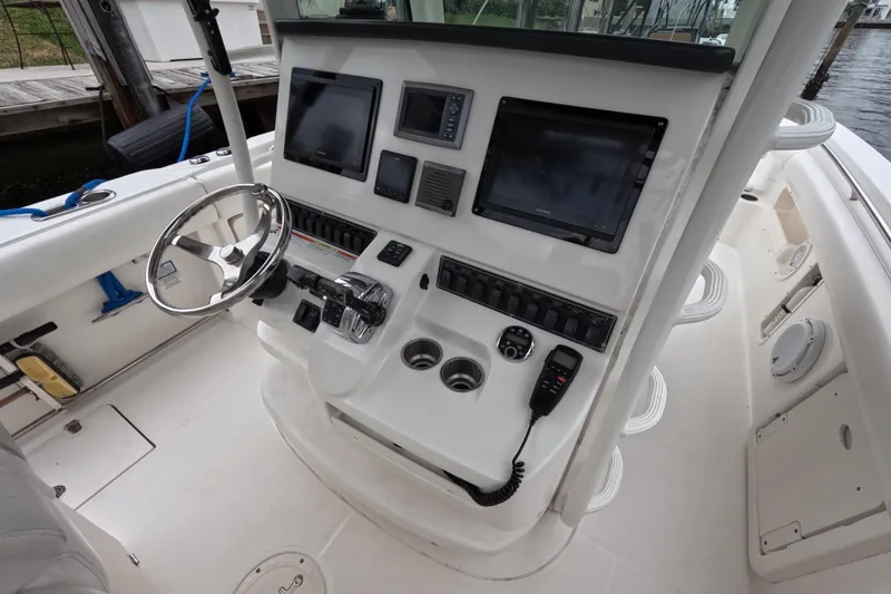 Slide: The Image of 2013 Boston Whaler 320 Outrage interior storage compartment with view of docked boat. - 46