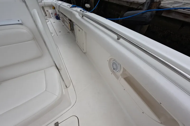 Slide: The Image of 2013 Boston Whaler 320 Outrage helm with steering wheel, controls, and navigation screens. - 47