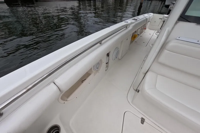 Slide: The Image of 2013 Boston Whaler 320 Outrage interior with white seating and deck details. - 48