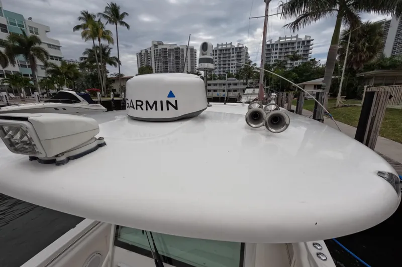 Slide: The Image of 2013 Boston Whaler 320 Outrage boat interior with white seating and storage compartments. - 49