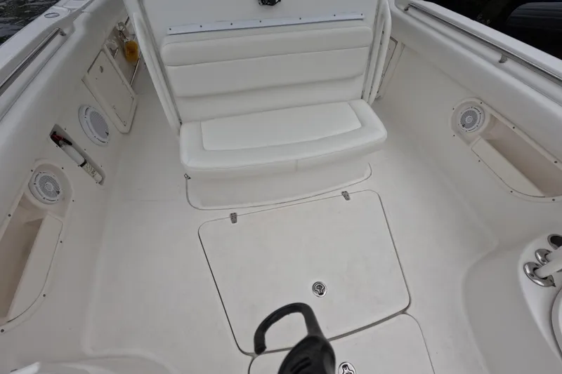 Slide: The Image of 2013 Boston Whaler 320 Outrage interior with white seating and storage compartment. - 51